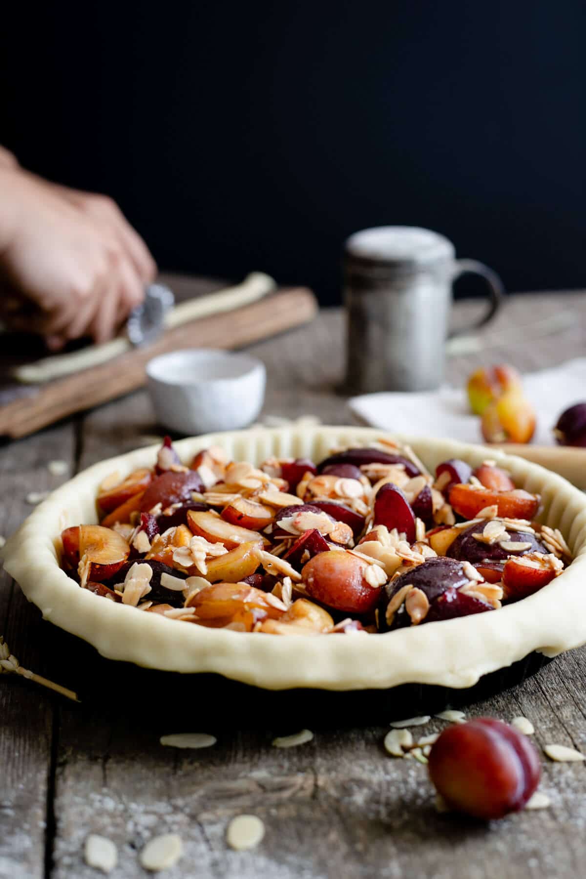 Unbaked plum pie with almonds