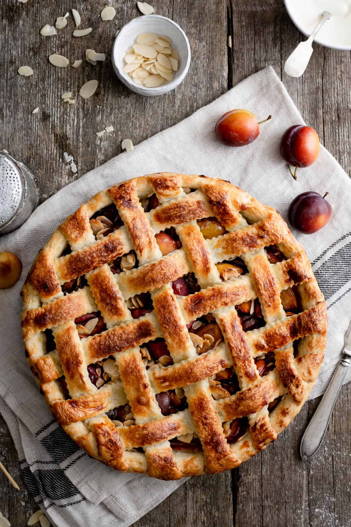 Plum and almond pie with decorative lattice pattern