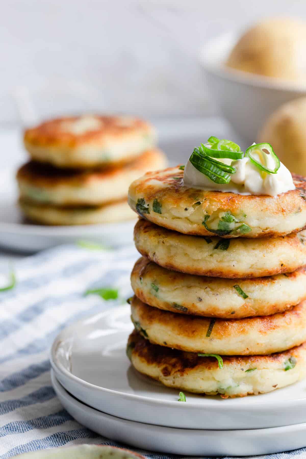 side close up of stack of potato patties with chives