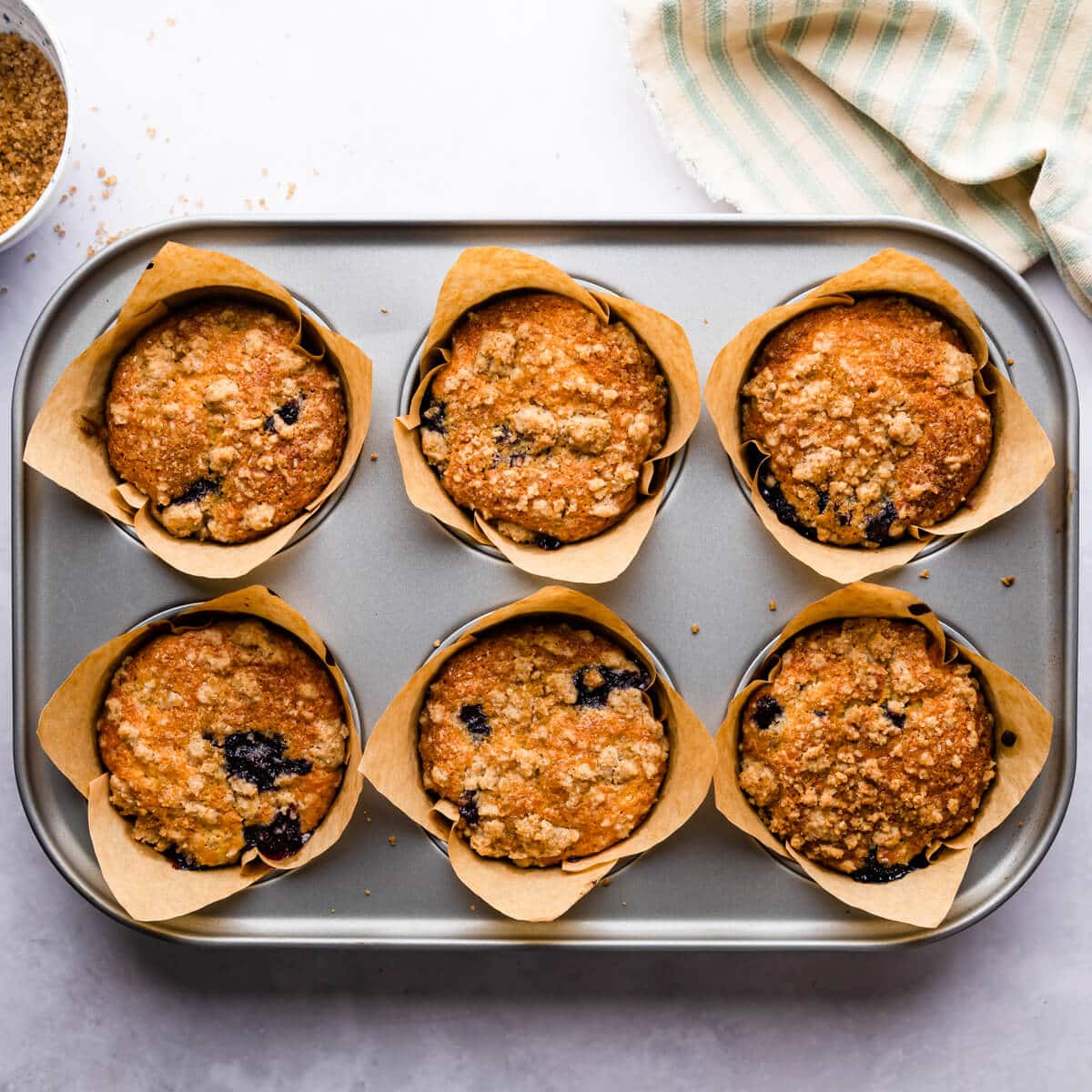 baked blueberry and lemon muffins inside of the baking tin.
