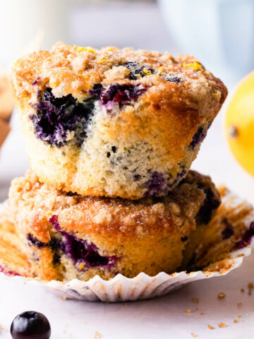 a stack of two blueberry and lemon muffins on top of each other.