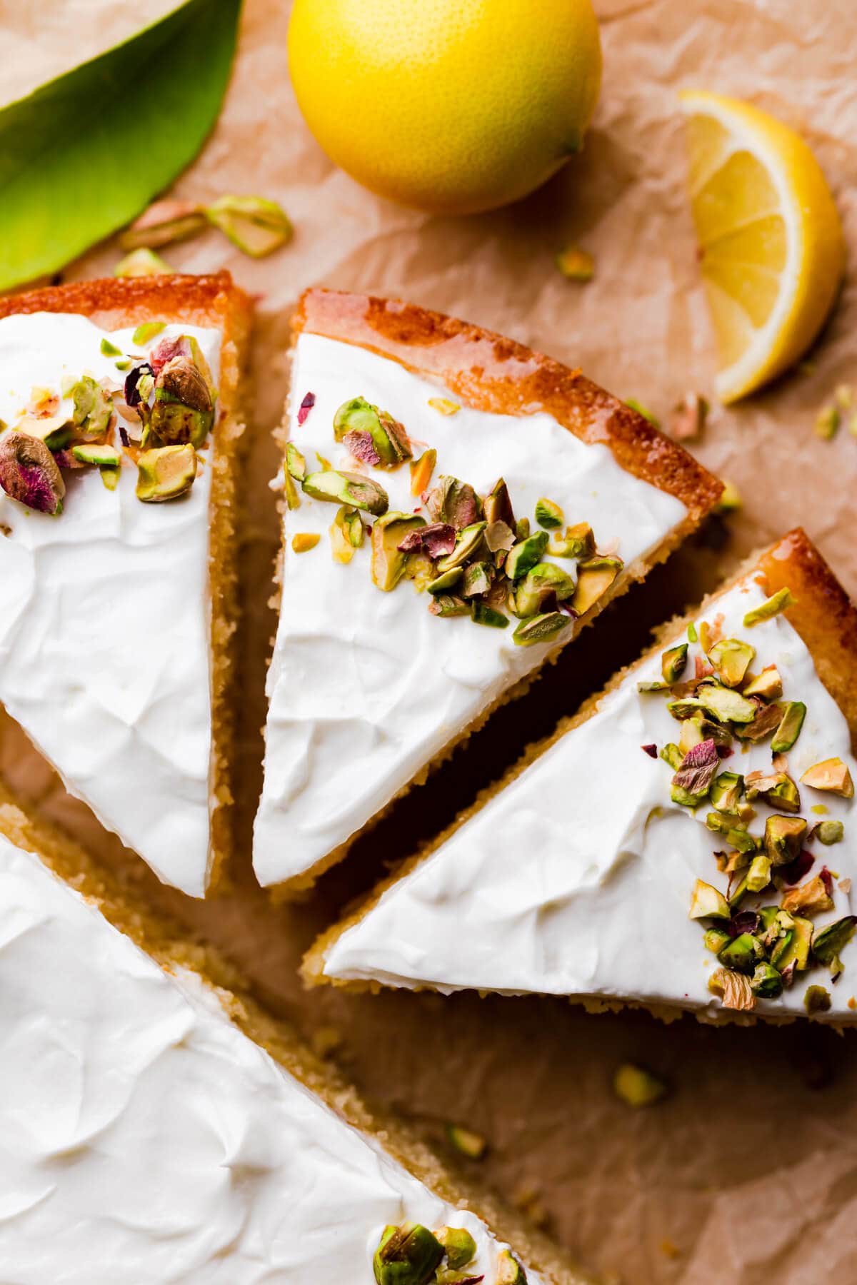 top view close up at a slice of semolina cake topped with yoghurt and pistachios