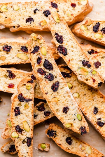 amaretto biscotti with cranberries and nuts on top of each other.