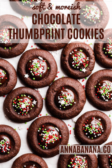 top view of chocolate thumbprint cookies with ganache and festive sprinkles and with text overlay
