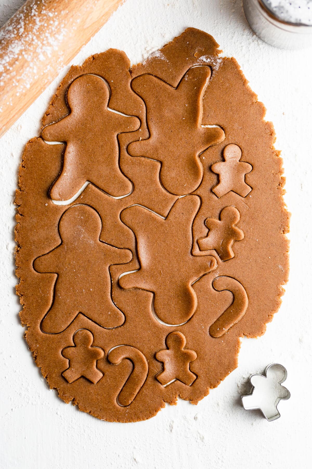 top view of rolled cookie dough with festive cookies cut outs