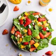 overhead view of strawberry mango salad topped with feta cheese