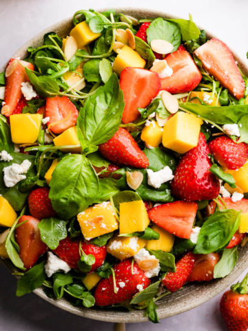 overhead close up at a bowl with strawberry mango salad