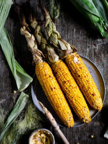 Overhead shot of oven-roasted corn on the cob with chilli butter