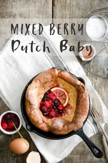 overhead shot of a small skillet with Dutch baby pancake with mixed berries
