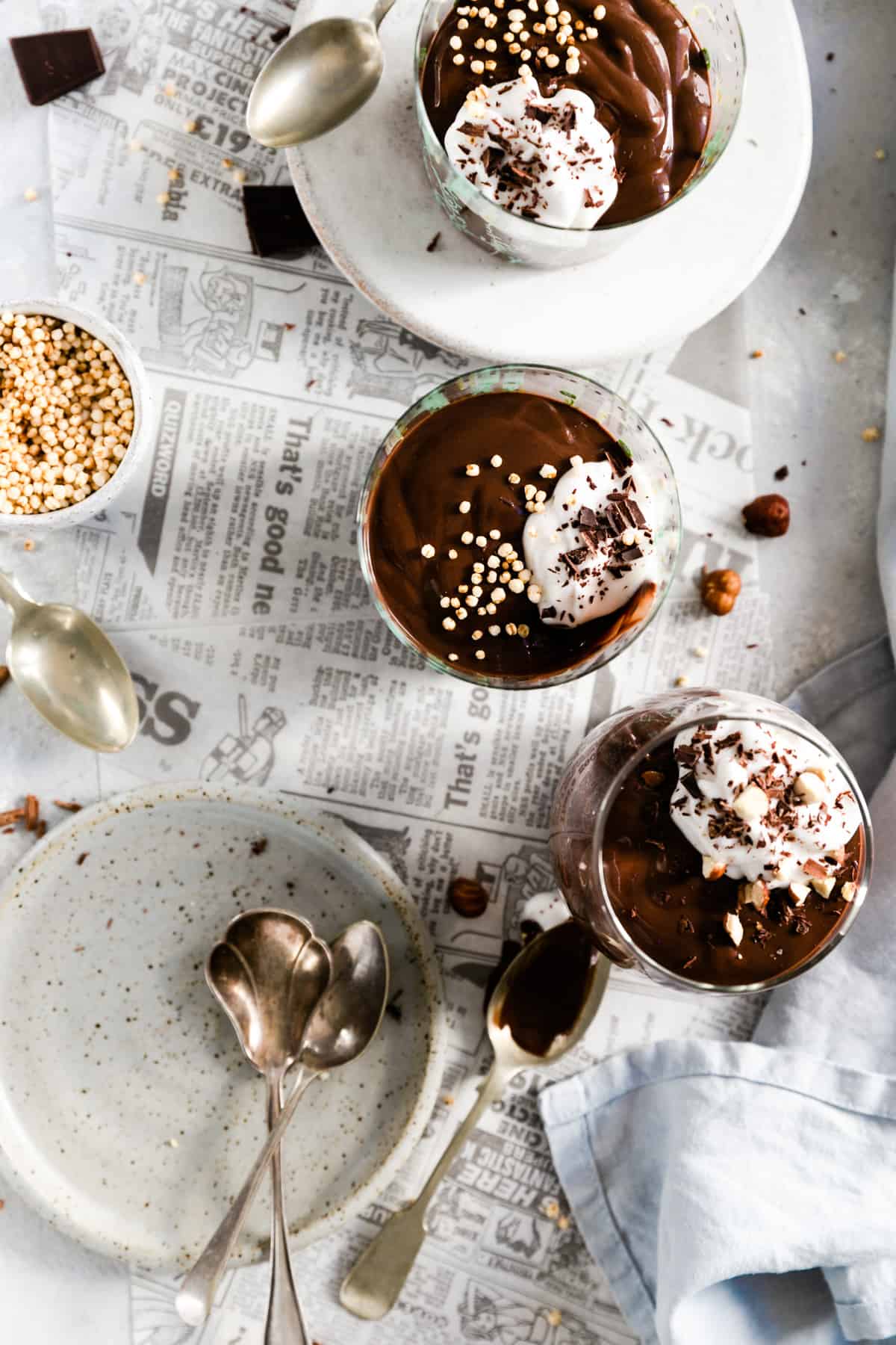 overhead shot of three glasses filled with vegan chocolate pudding