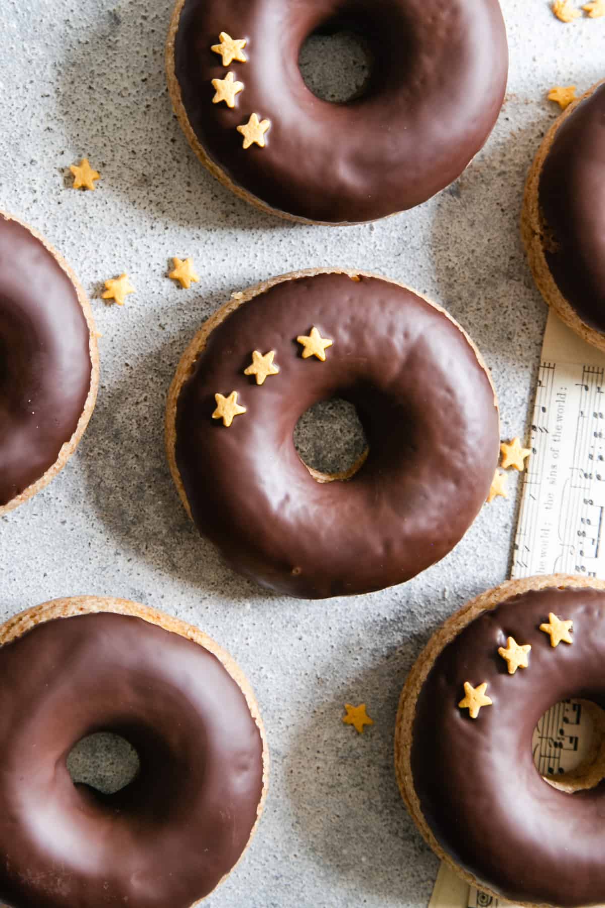an overhead close-up of baked doughnuts with chocolate glaze