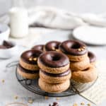 small stacks of baked doughnuts on a round cooling rack