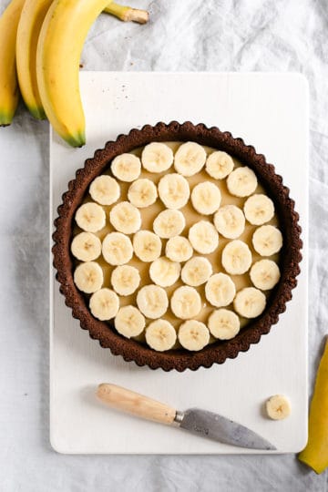 overhead shot of chocolate coconut banoffee pie without whipped cream on top, showing the banana layer