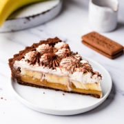 side close up at a slice of vegan banoffee pie on a dessert plate