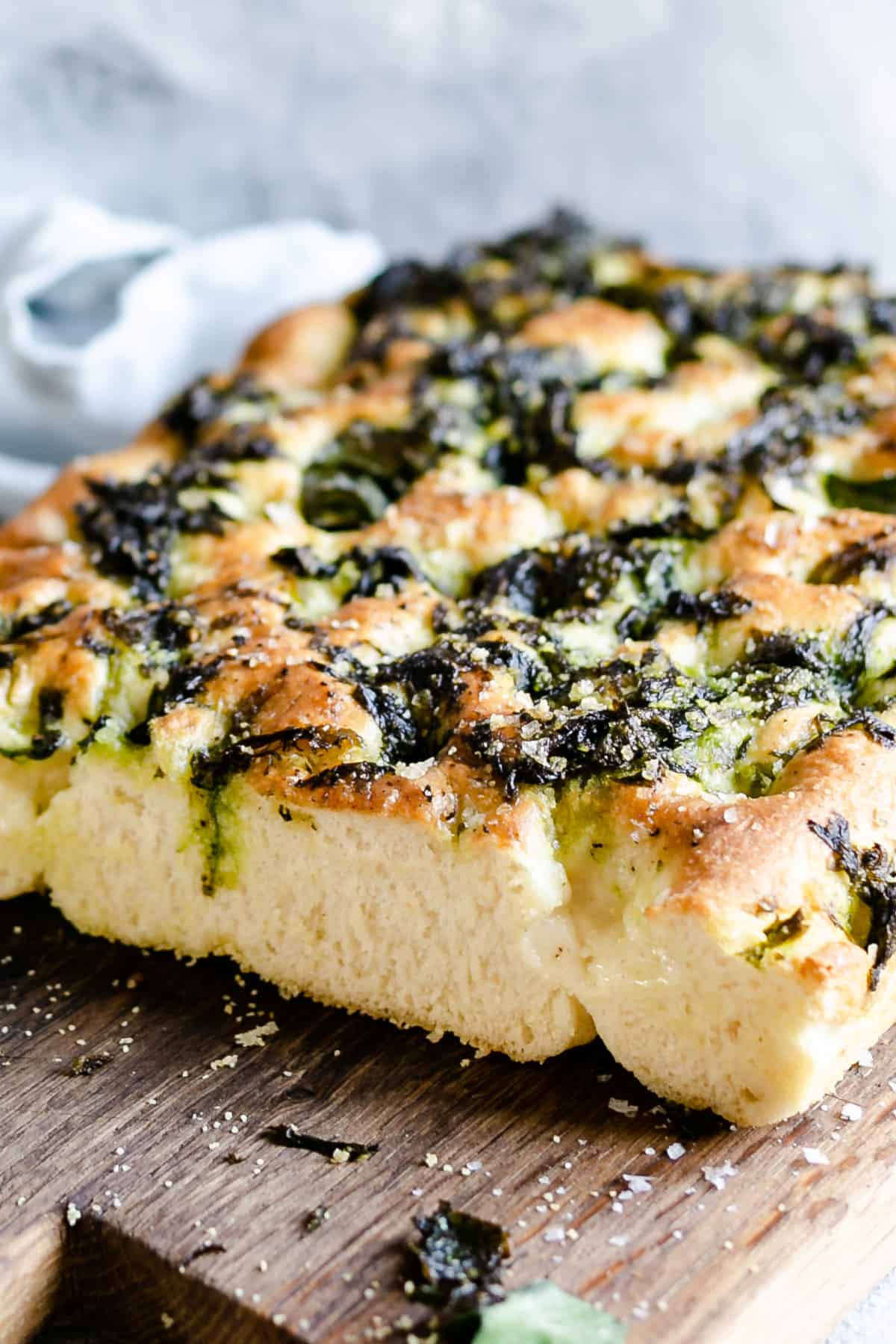 a 45 degree angle close-up shot, showing the spongy texture of wild garlic focaccia