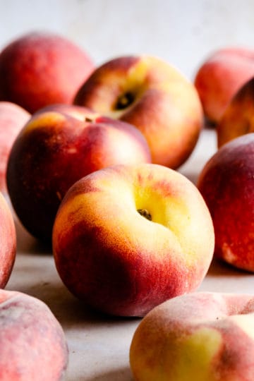 a side view of whole fresh peaches