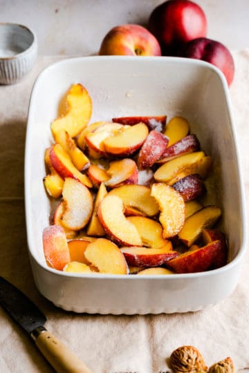 sliced peaches in a baking dish