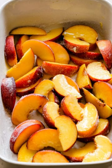 close up of sliced peaches in a baking dish