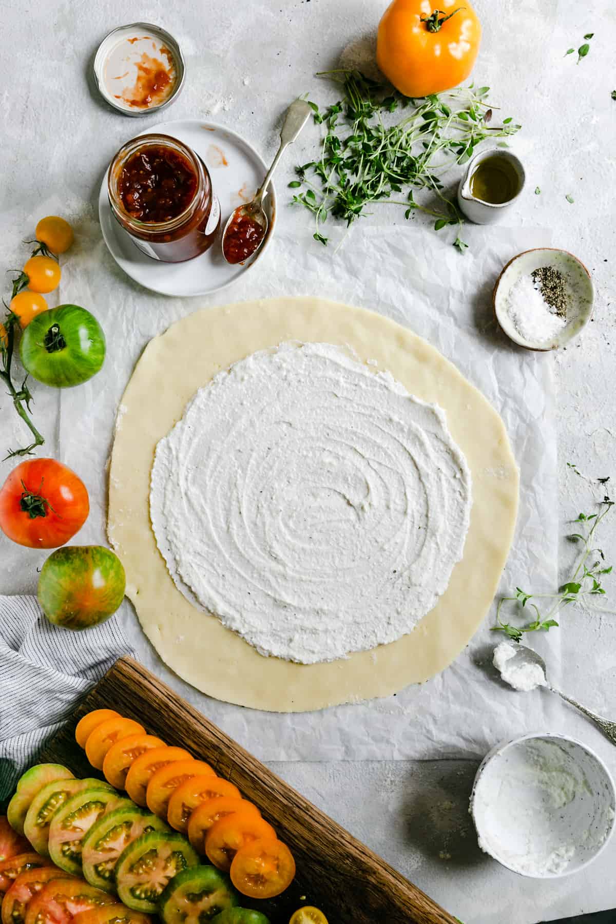 top view of a shortcrust pastry rolled into a circle and topped with ricotta cheese