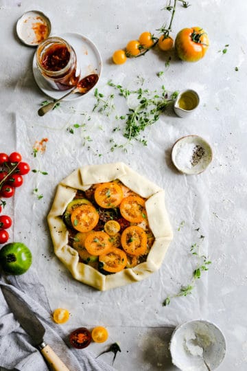 overhead view of unbaked summer tomato galette