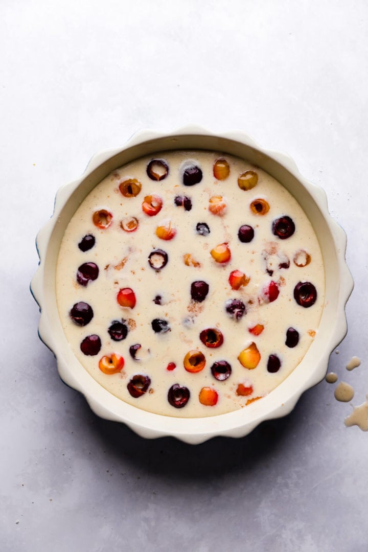 top view of a baking dish filled with cherries and clafoutis batter