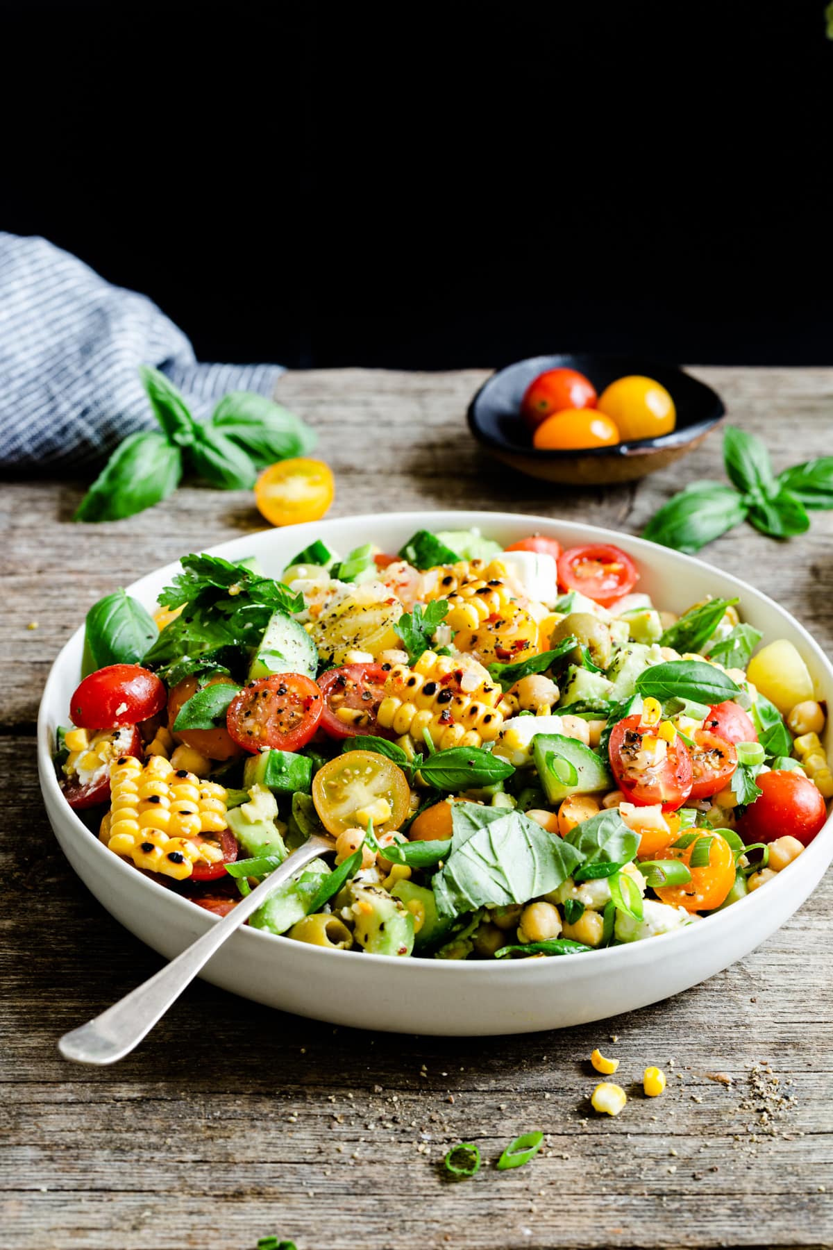 a side angle view of a bowl with grilled corn salad