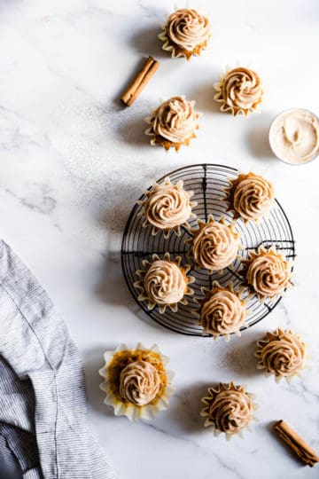top view of pumpkin cupcakes with chai frosting on a marble surface