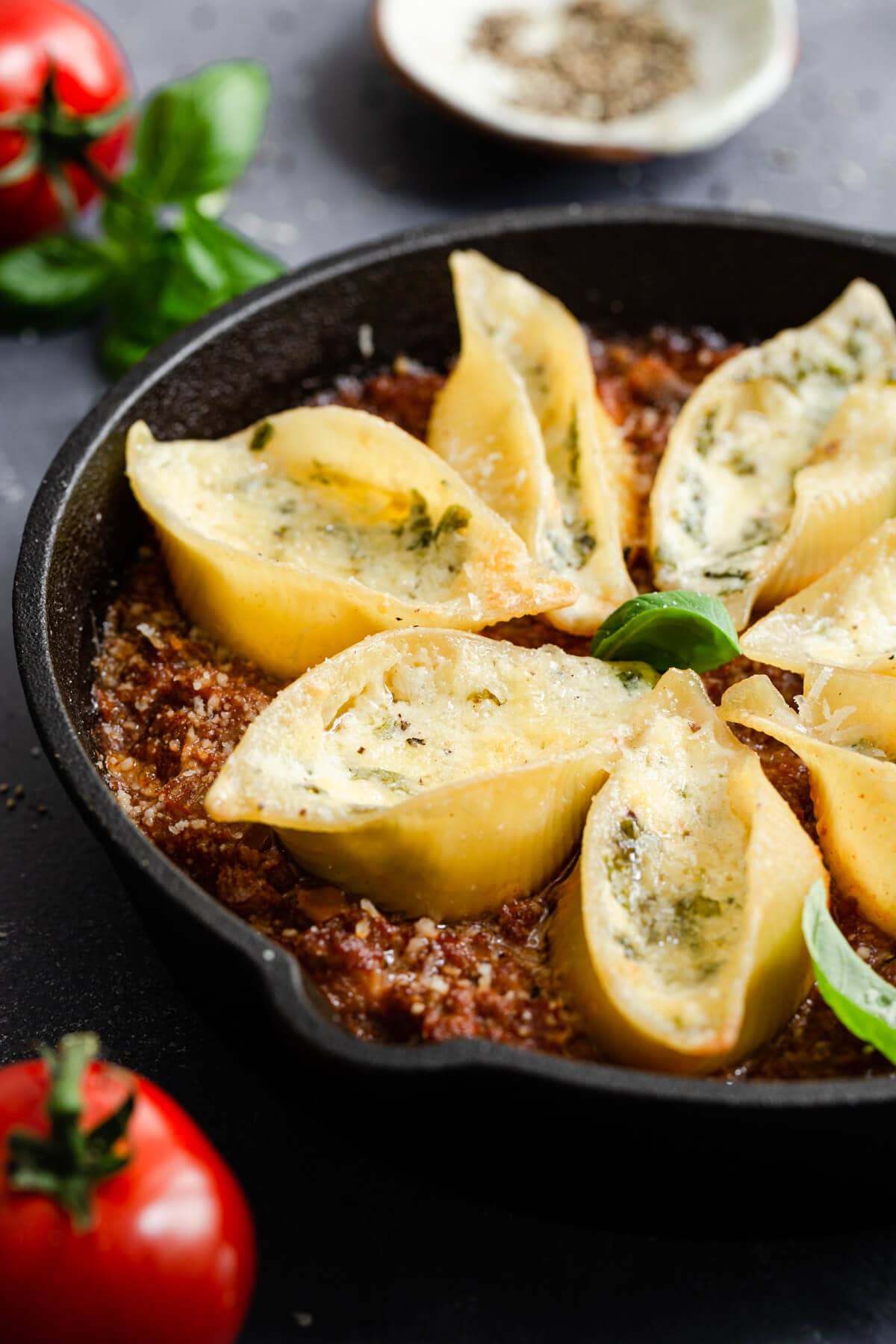 side view of stuffed pasta shells bake in a pan