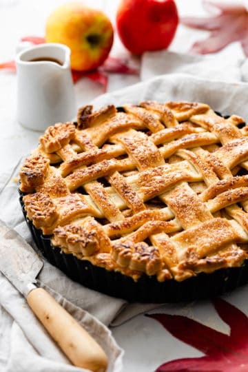 side close up of a baked apple pie with lattice top