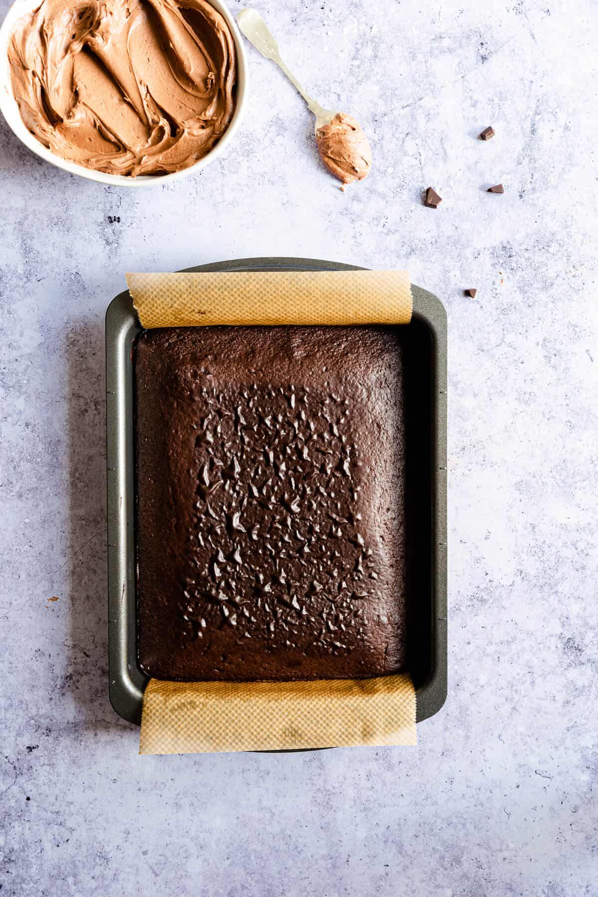 top view of unfrosted chocolate cake in a baking tin