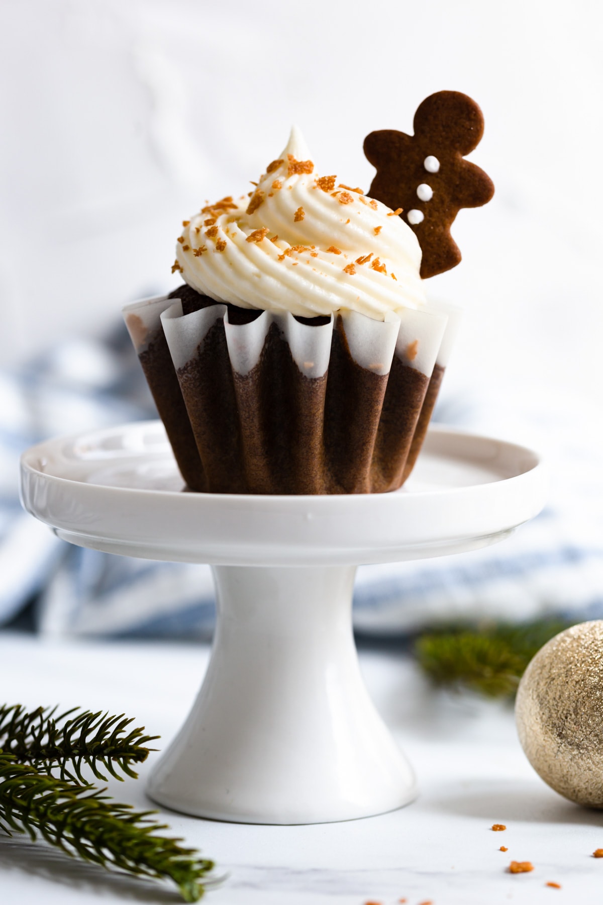 a side super close up of gingerbread cupcake on a cupcake stand