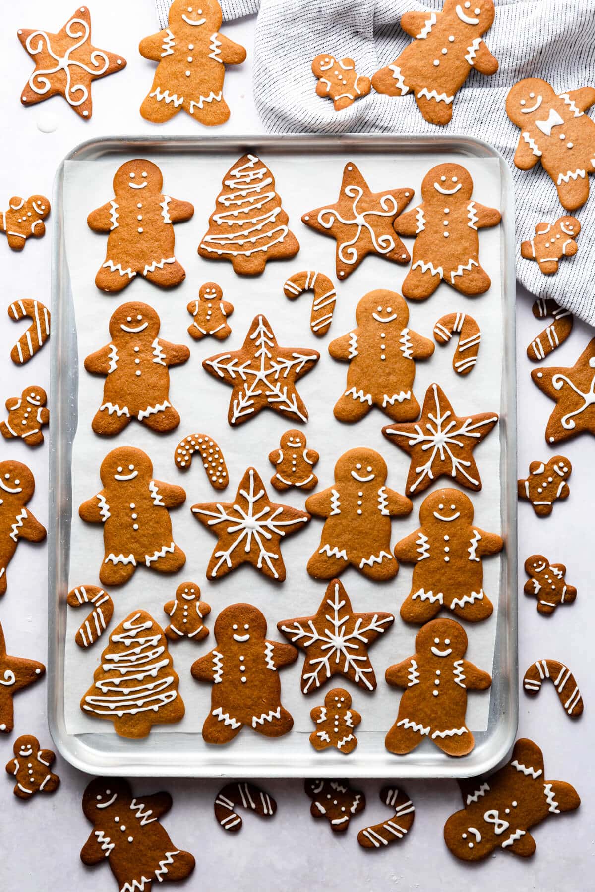 overhead shot of gingerbread cookies decorated with icing on a baking sheet