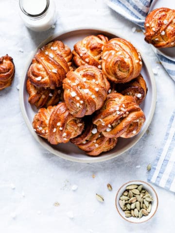 overhead shot of a plate with golden cardamom buns