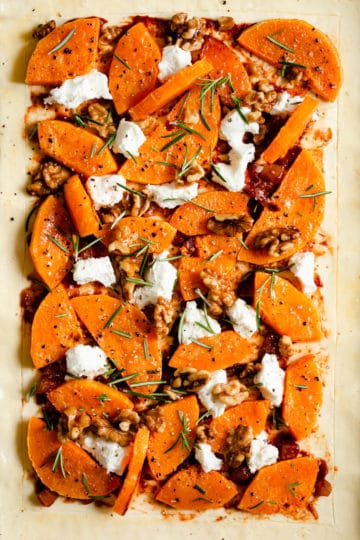 close up of butternut squash tart with goats' cheese and rosemary