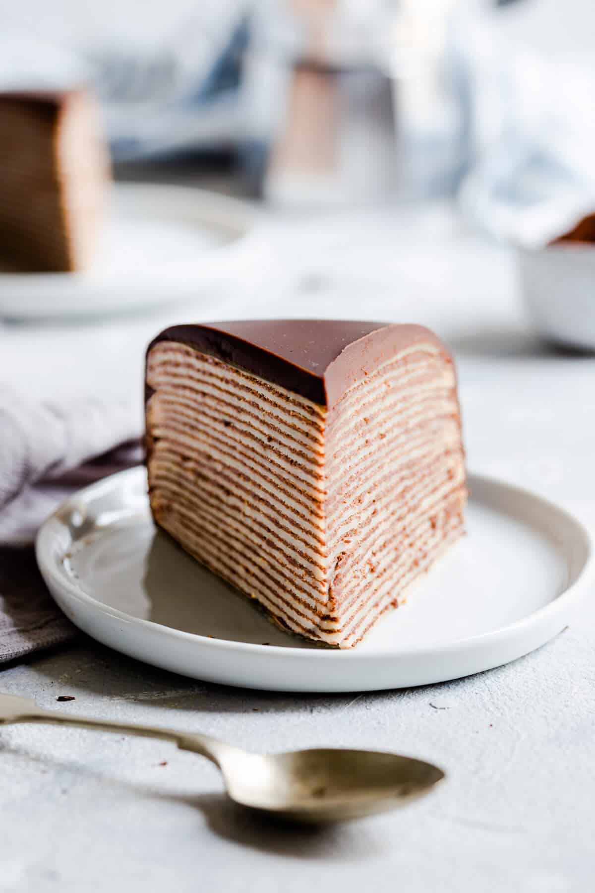 straight ahead close up of a slice of chocolate crepe cake