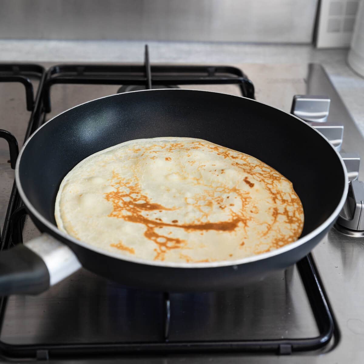 45 degree angle view at frying pan with crepe