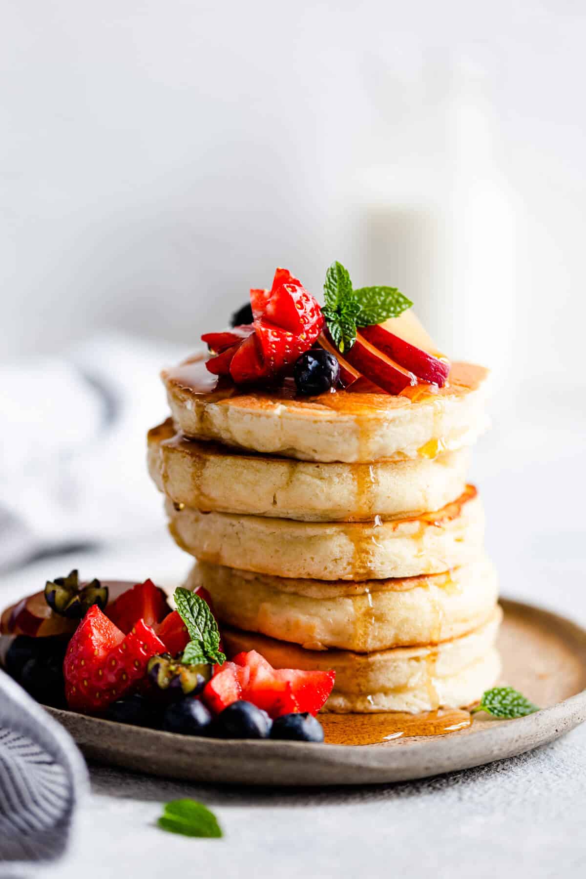 side close up of a stack of 5 fluffy pancakes