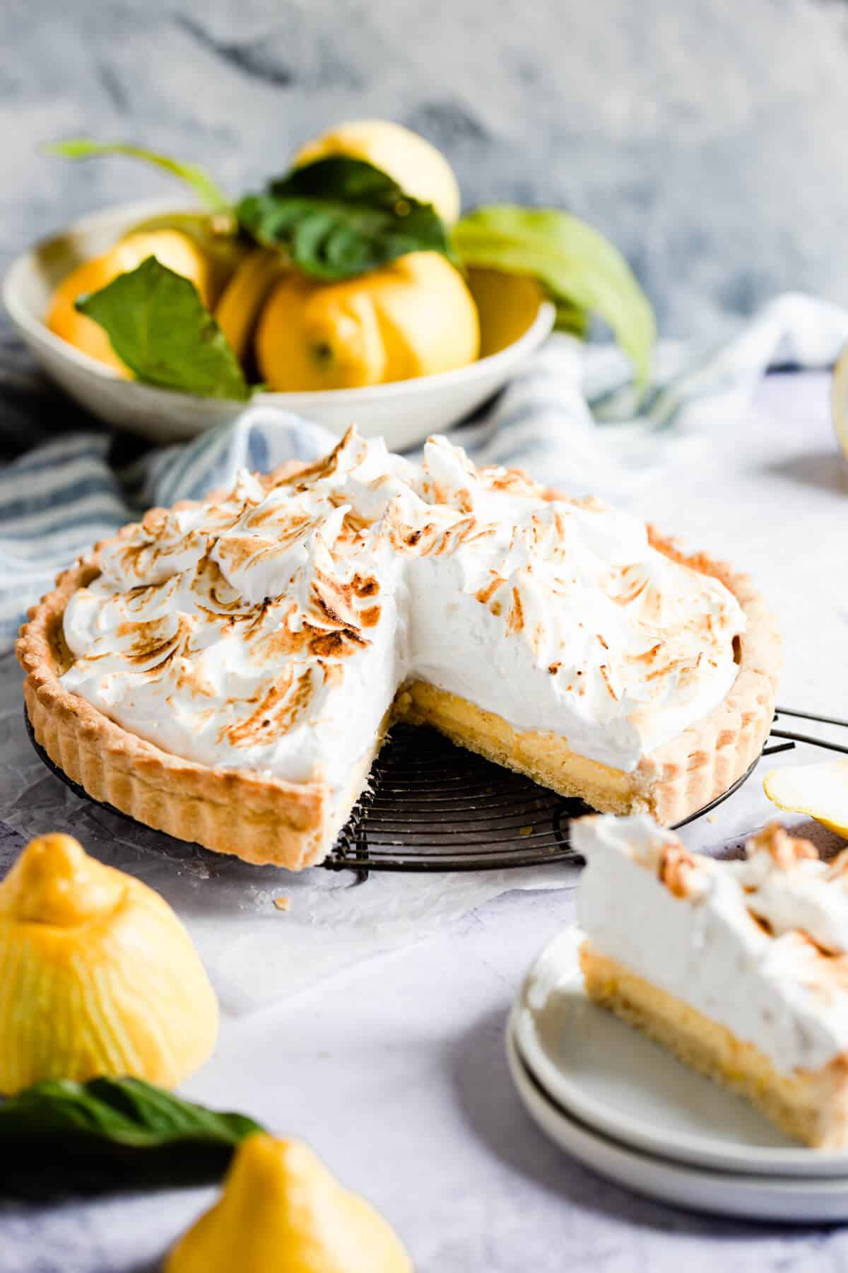 side view of a lemon pie with a slice cut out