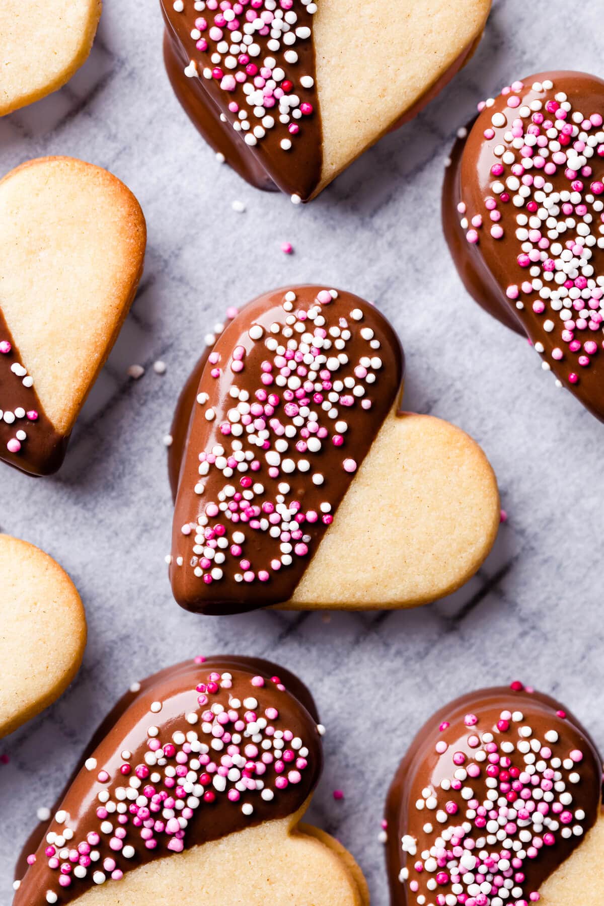 heart sugar cookies dipped in chocolate and topped with sprinkles.