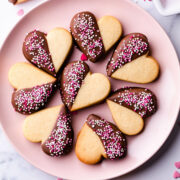 heart shaped sugar cookies on a pink plate.