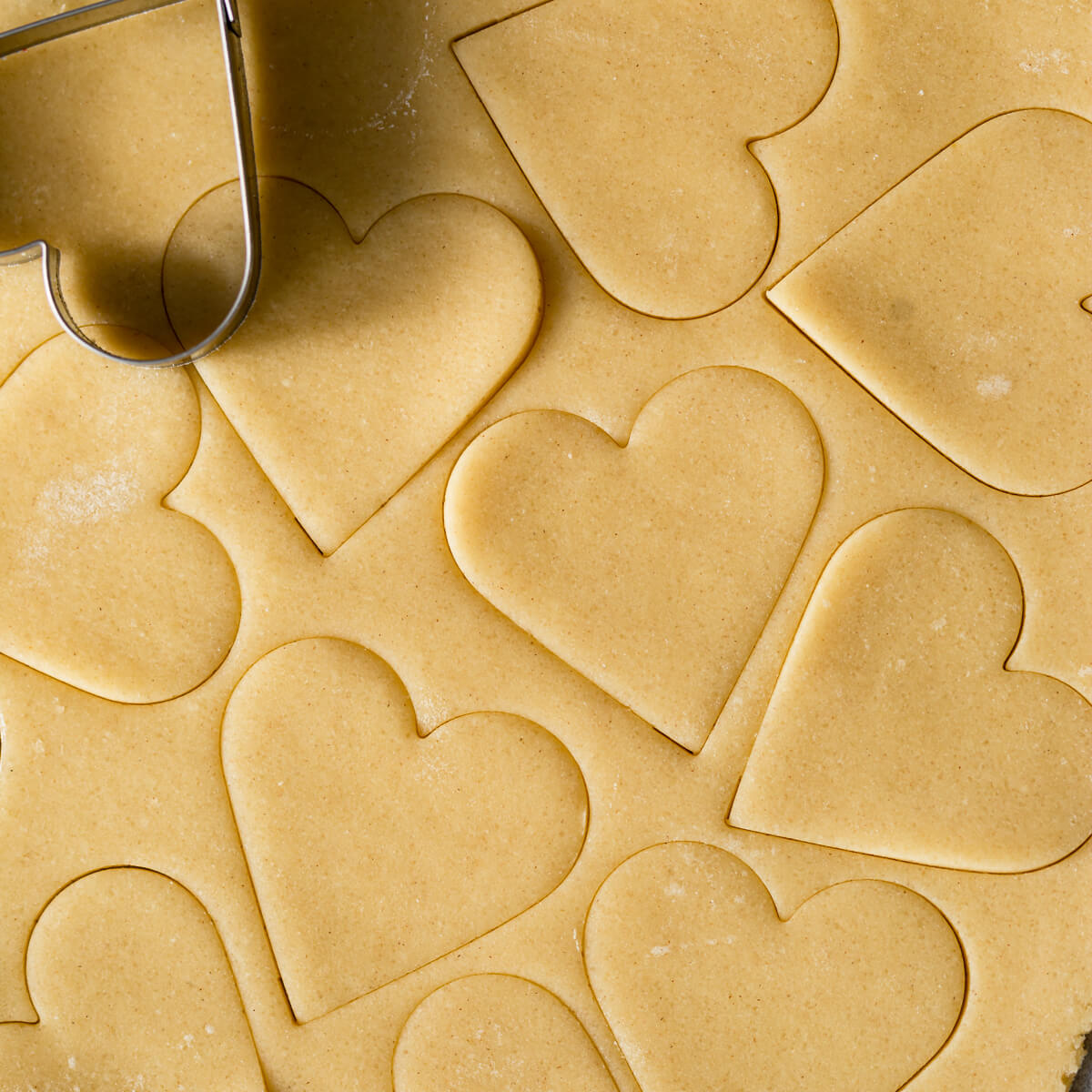 sugar cookie dough with heart-shaped cut-outs.