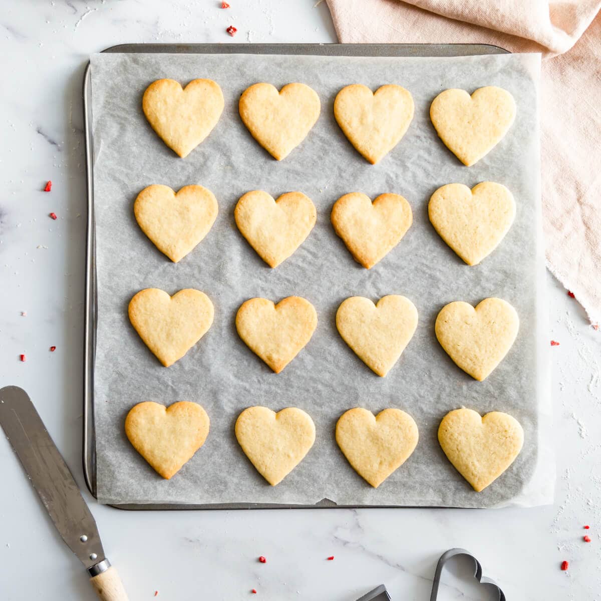 baking sheet with baked valentine sugar cookies.