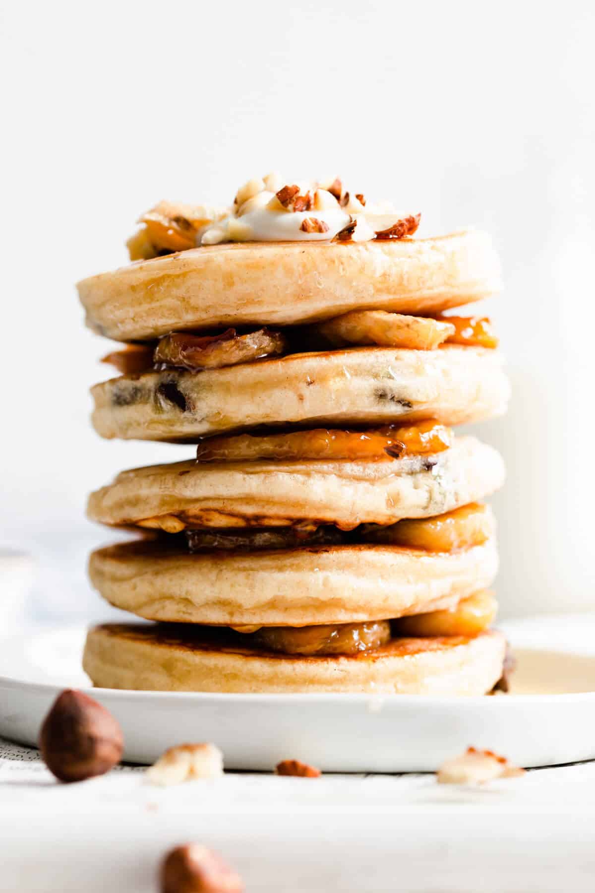 side close up of stack of pancakes and caramelised bananas between them