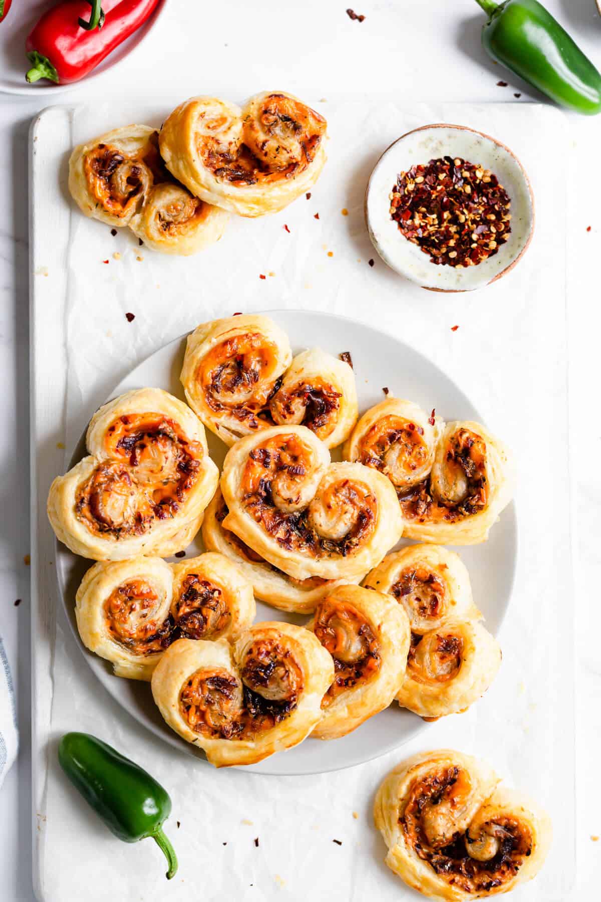 top view of a plate filled with cream cheese and caramelised onion palmiers 