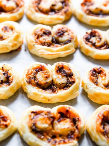side close up of savoury palmiers on white surface