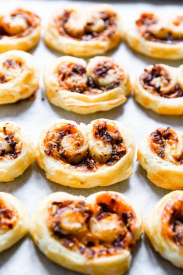 side close up of savoury palmiers on white surface
