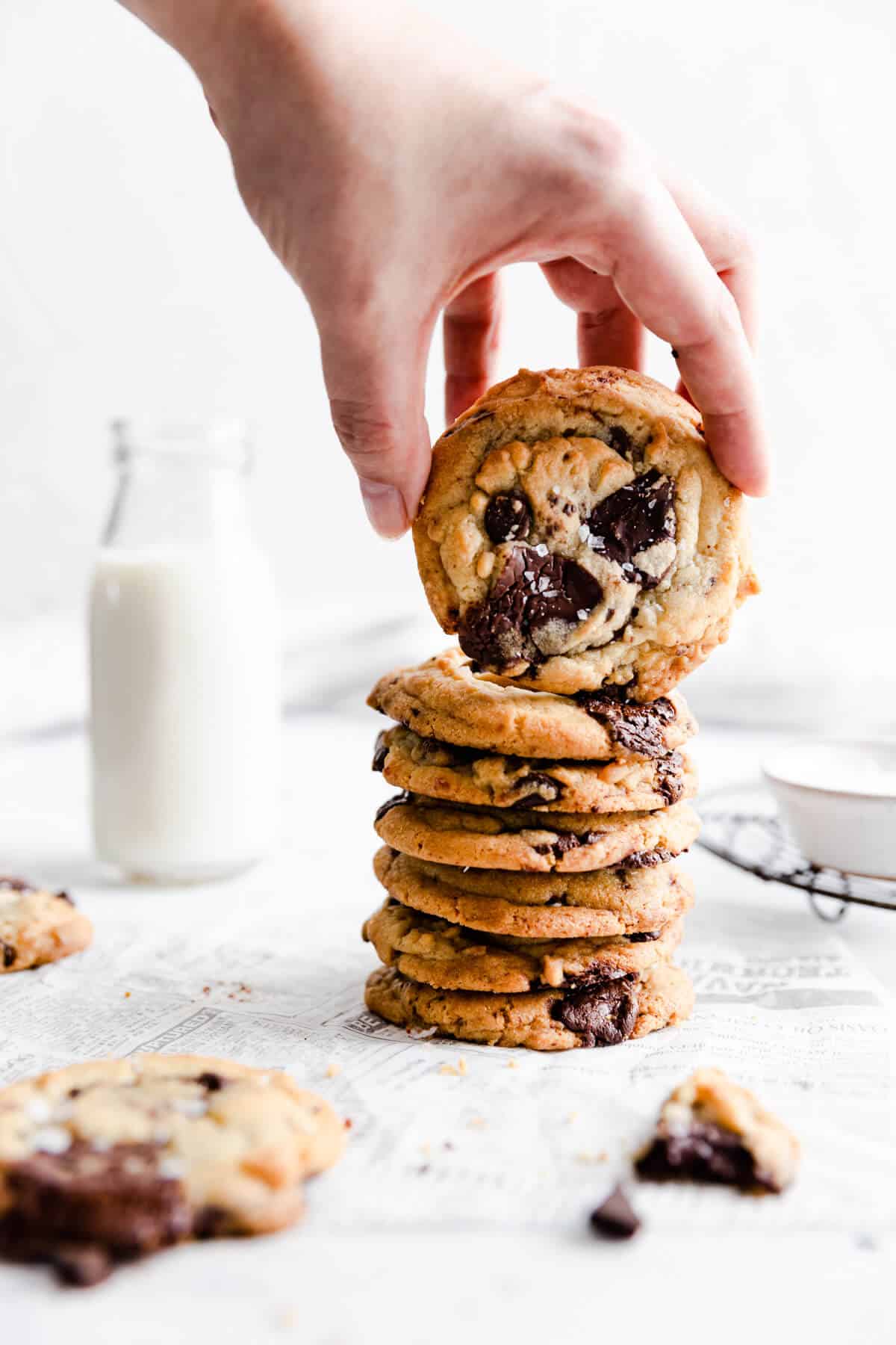 side view of a person lifting a cookie from cookie stack
