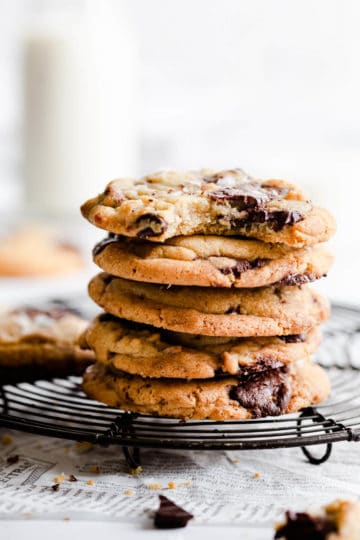 side close up of a stack of cookies with top cookie missing a bite