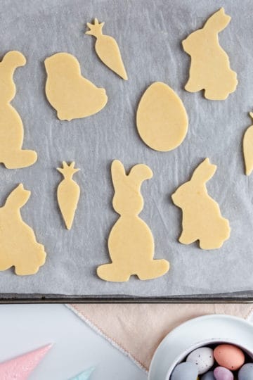 overhead view of unbaked sugar cookies in shape of bunnies and carrots