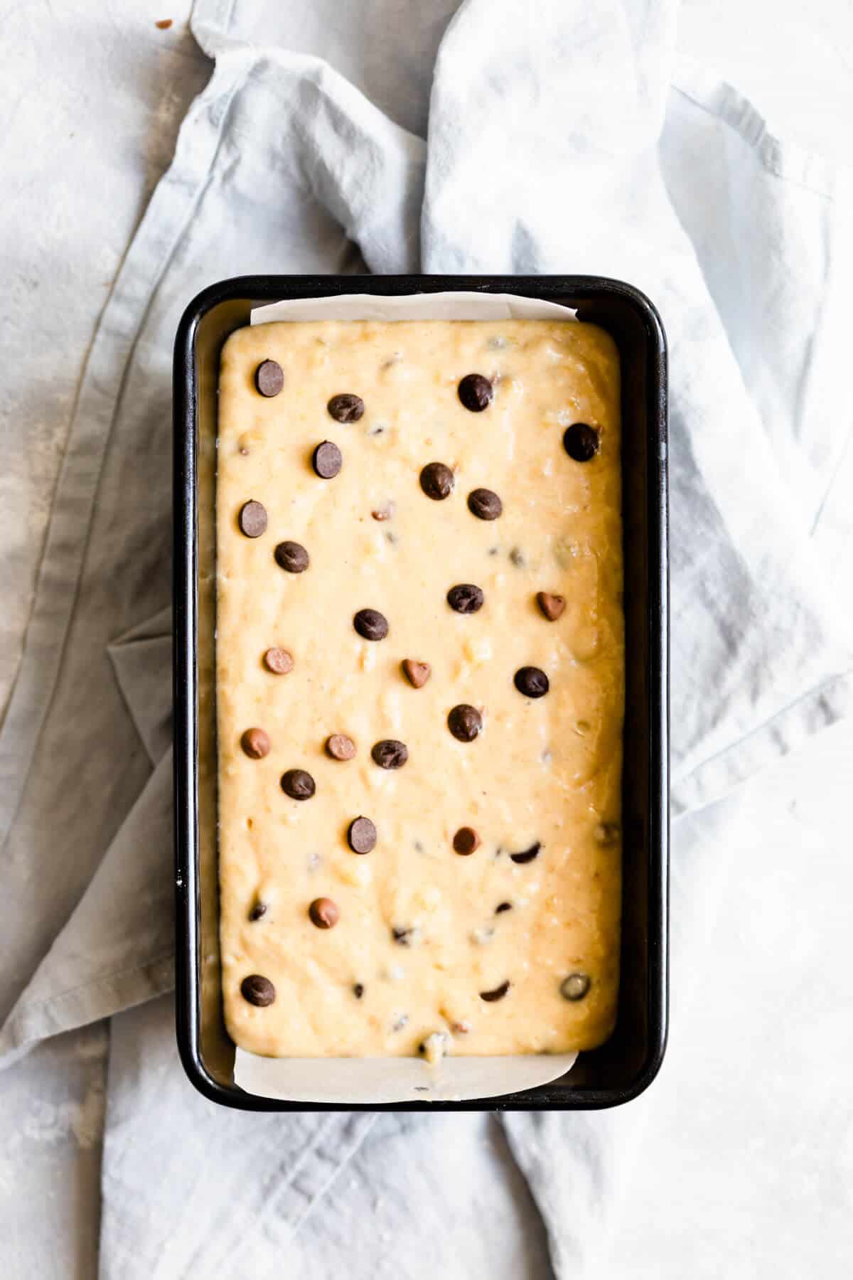 overhead shot of a loaf tin with banana bread batter inside